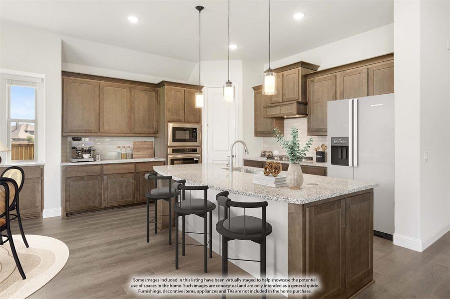 Kitchen with brown wood cabinets, large island with granite countertop, and four bar stools under pendant lights Kitchen with brown wood cabinets, large island with granite countertop, and four bar stools under pendant lights