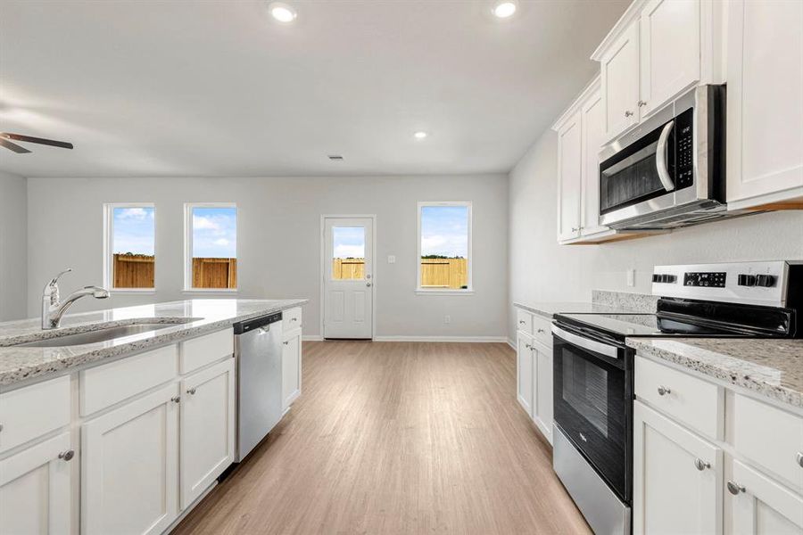 The kitchen has a bright and inviting view of the backyard and includes brand new Whirlpool appliances.