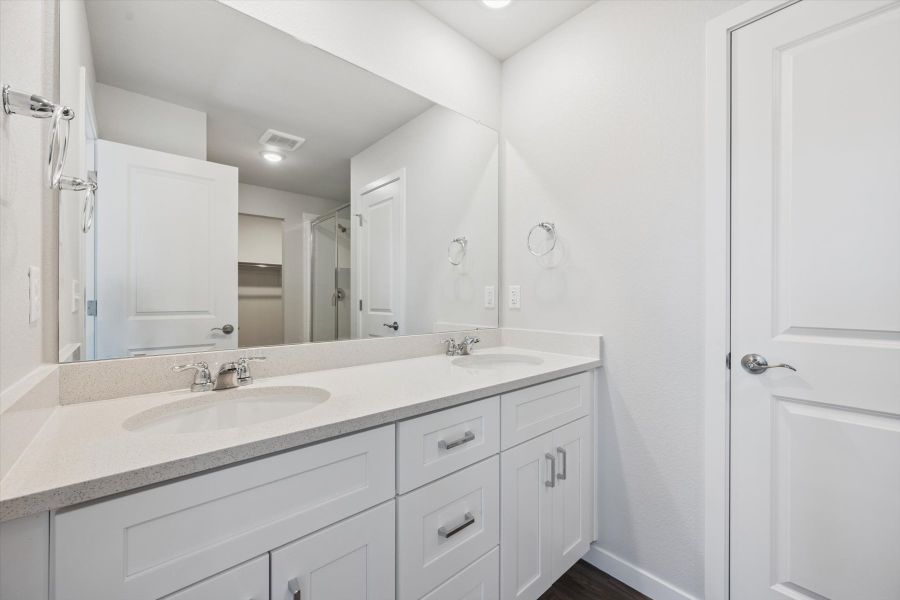 A bathroom with a large mirror. A bathroom with a large mirror.