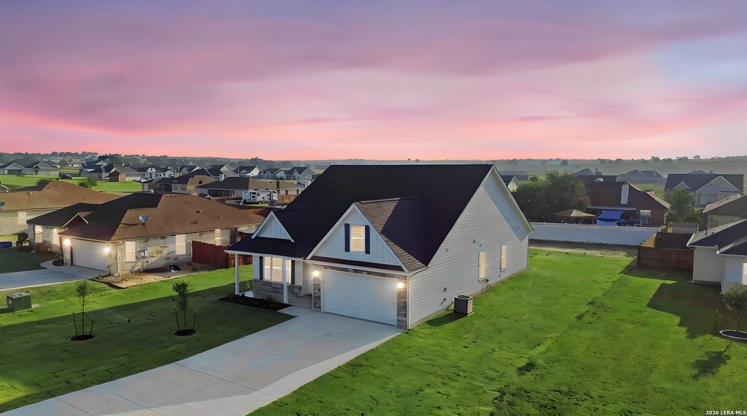 Front exterior of a new home in Las Palomas Country Club Estates, La Vernia, TX, highlighting curb appeal (Image 30).