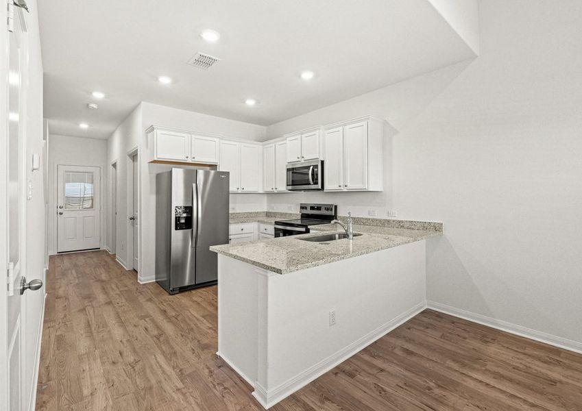 The foyer leads to a spacious kitchen and dining room