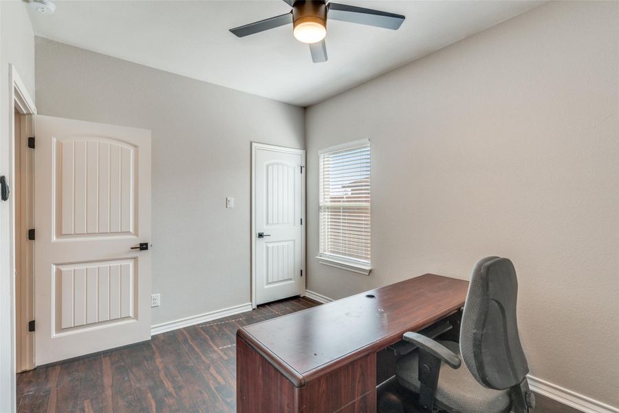Office with dark wood-style floors and ceiling fan Office with dark wood-style floors and ceiling fan