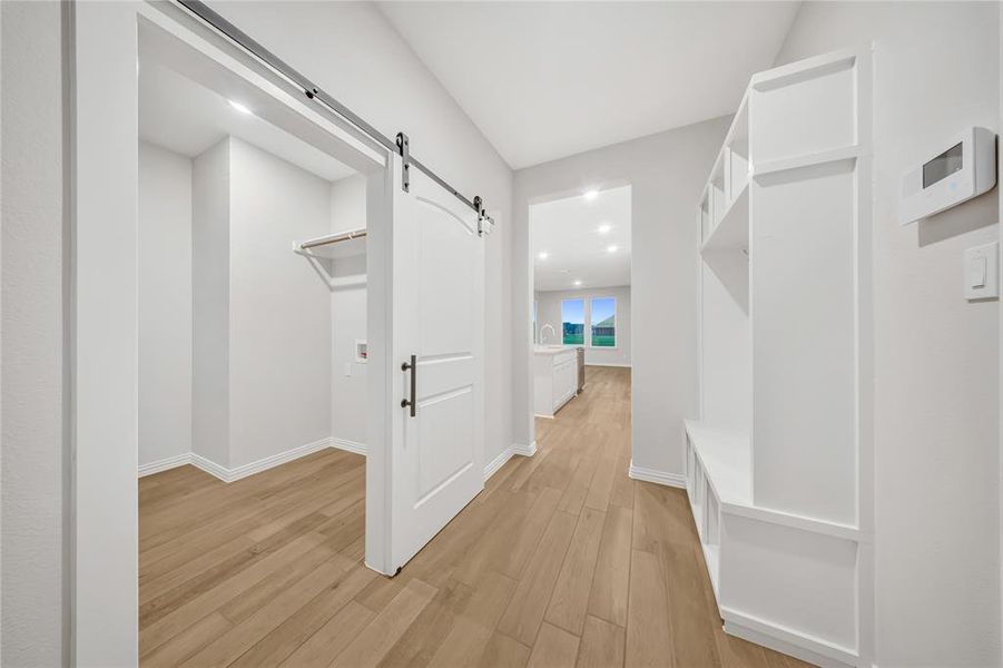 Mudroom with a barn door, light wood-type flooring, and recessed lighting Mudroom with a barn door, light wood-type flooring, and recessed lighting