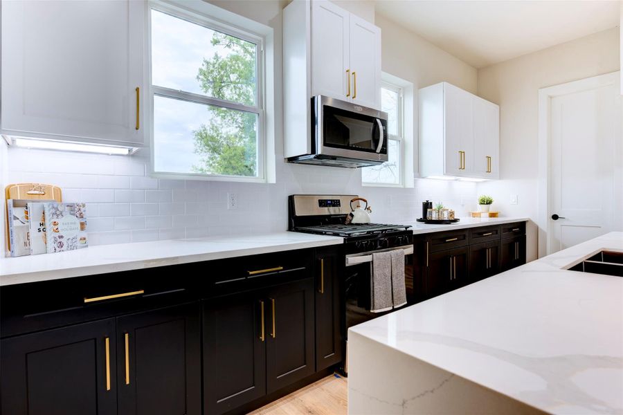 Black cabinets with brass hardware throughout the home Black cabinets with brass hardware throughout the home