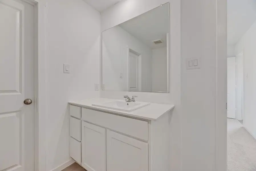 Bathroom with vanity and baseboards