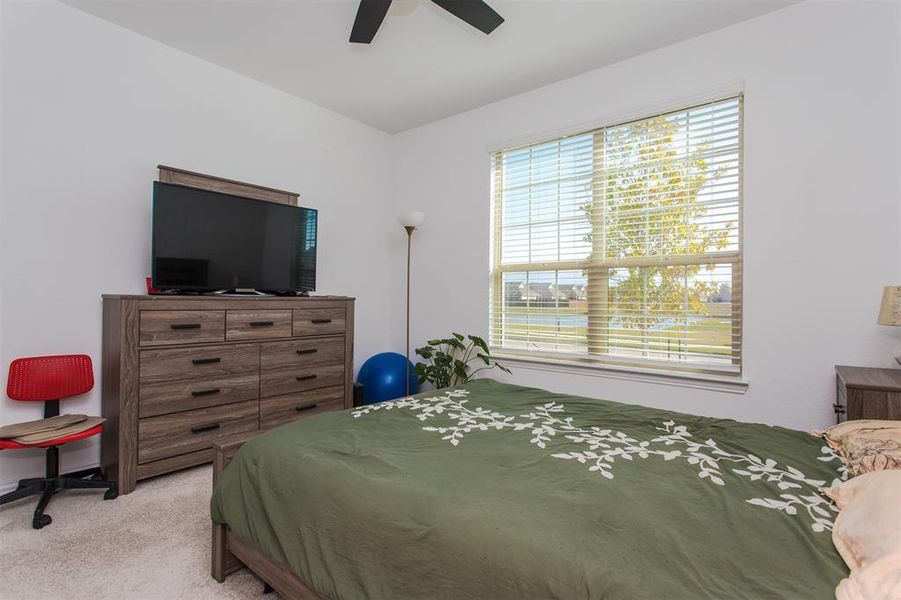 Bedroom featuring ceiling fan and light colored carpet