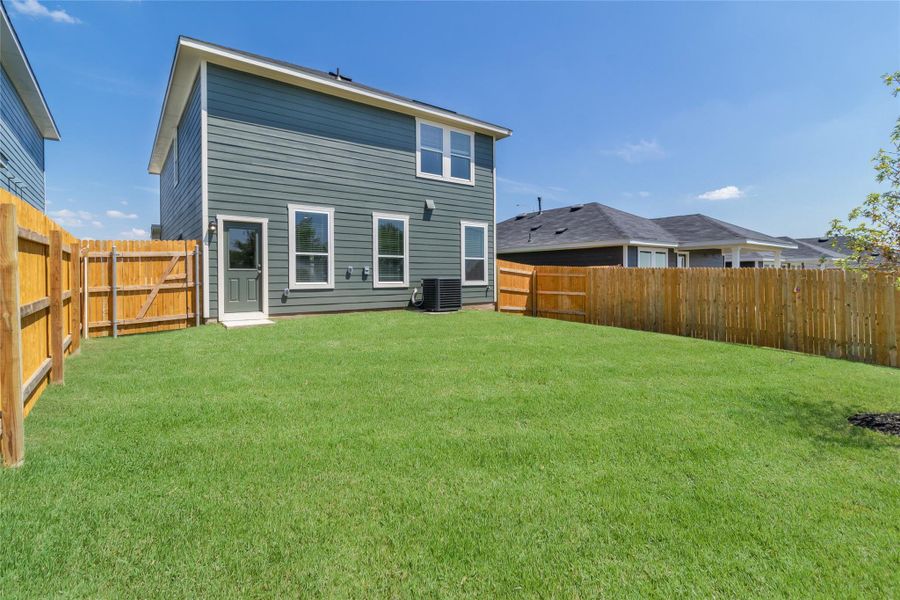 Front exterior of a new home in Marigold, Uhland, TX, highlighting curb appeal (Image 1).