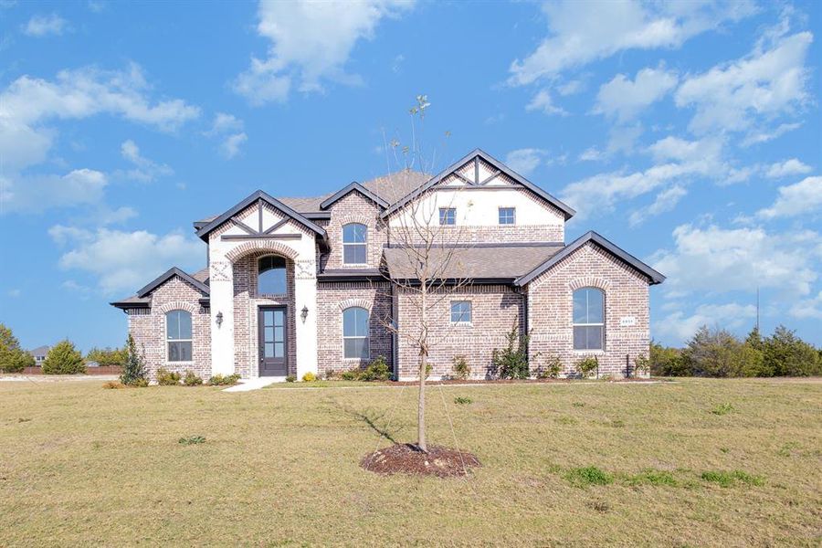 Front exterior of a new home in Sagebrush Addition, Midlothian, TX, highlighting curb appeal (Image 2).