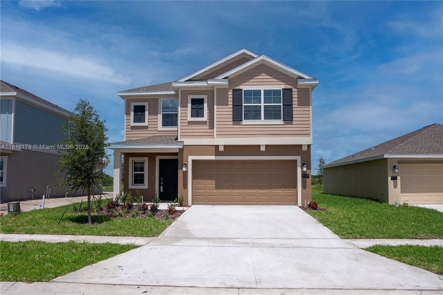 Front exterior of a new home in Inman Groves, Winter Haven, FL, highlighting curb appeal (Image 2). Front exterior of a new home in Inman Groves, Winter Haven, FL, highlighting curb appeal (Image 2).