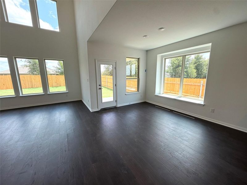 Unfurnished living room with dark wood-type flooring Unfurnished living room with dark wood-type flooring