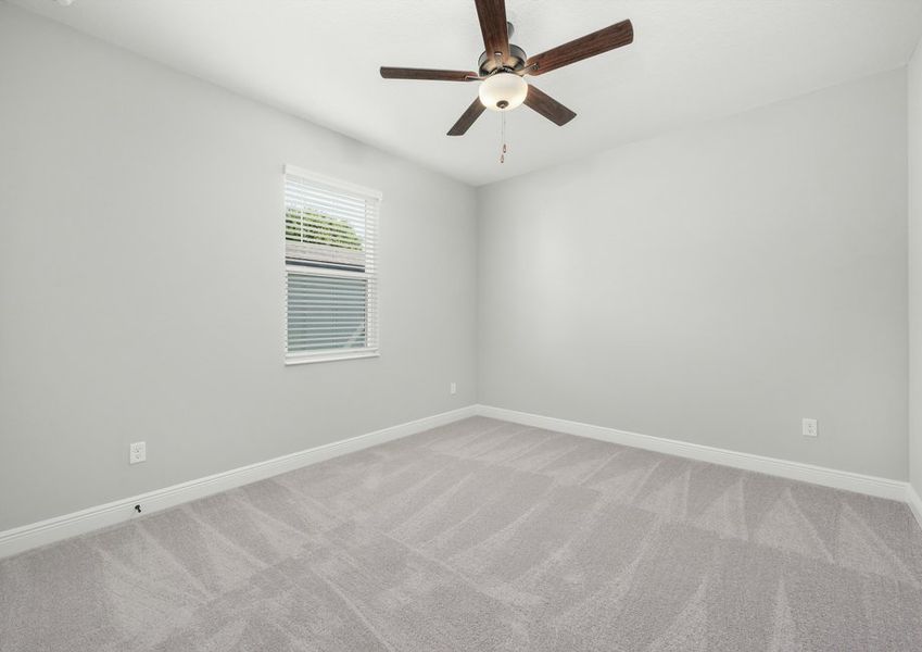 One of the secondary bedrooms that includes lush carpeting