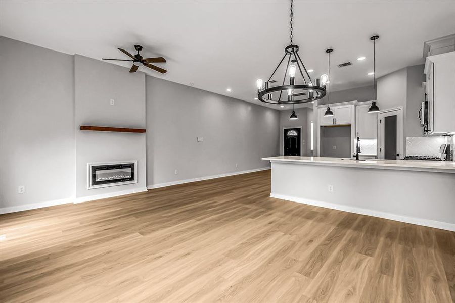 Breakfast bar provides additional seating. Entry to the home is just beyond.