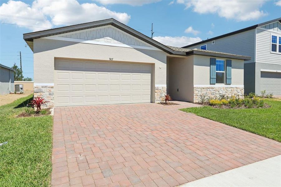 Front exterior of a new home in Lawson Dunes - Signature Series, Haines City, FL, highlighting curb appeal (Image 21). Front exterior of a new home in Lawson Dunes - Signature Series, Haines City, FL, highlighting curb appeal (Image 21).