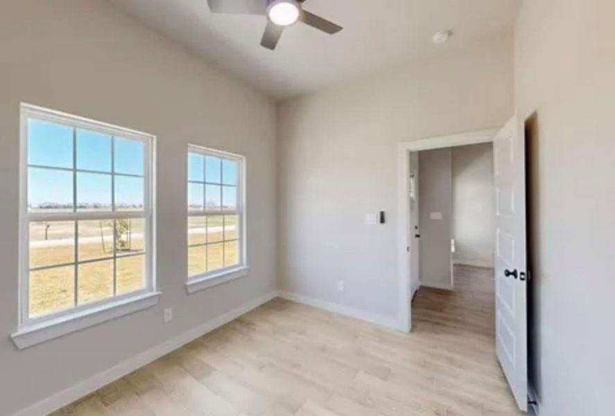 Spare room featuring light wood finished floors and ceiling fan Spare room featuring light wood finished floors and ceiling fan