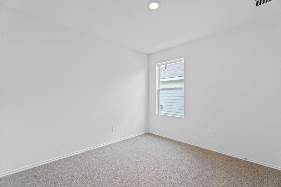 Carpeted empty room with baseboards Carpeted empty room with baseboards