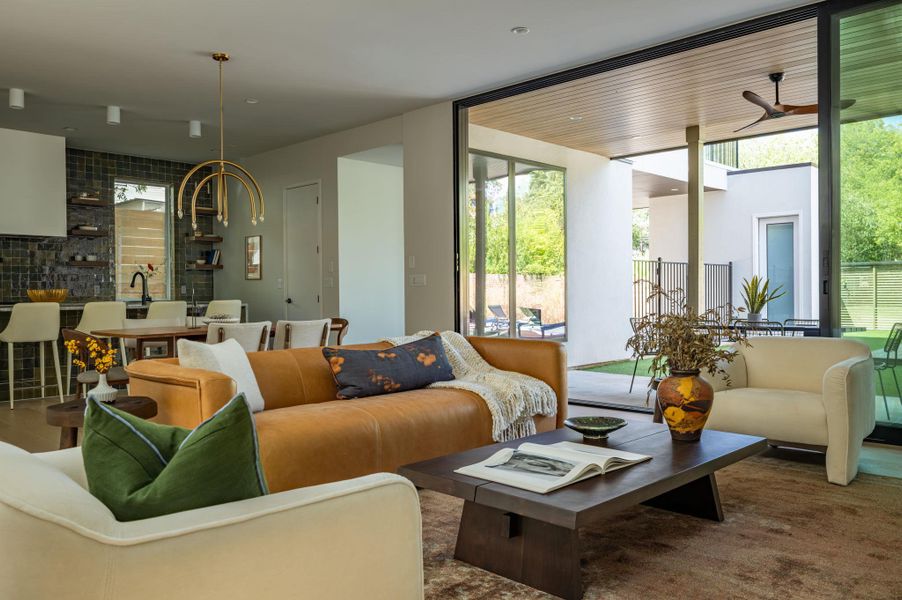 Massive sliding glass doors merge the indoor living space seamlessly with the private patio. Massive sliding glass doors merge the indoor living space seamlessly with the private patio.