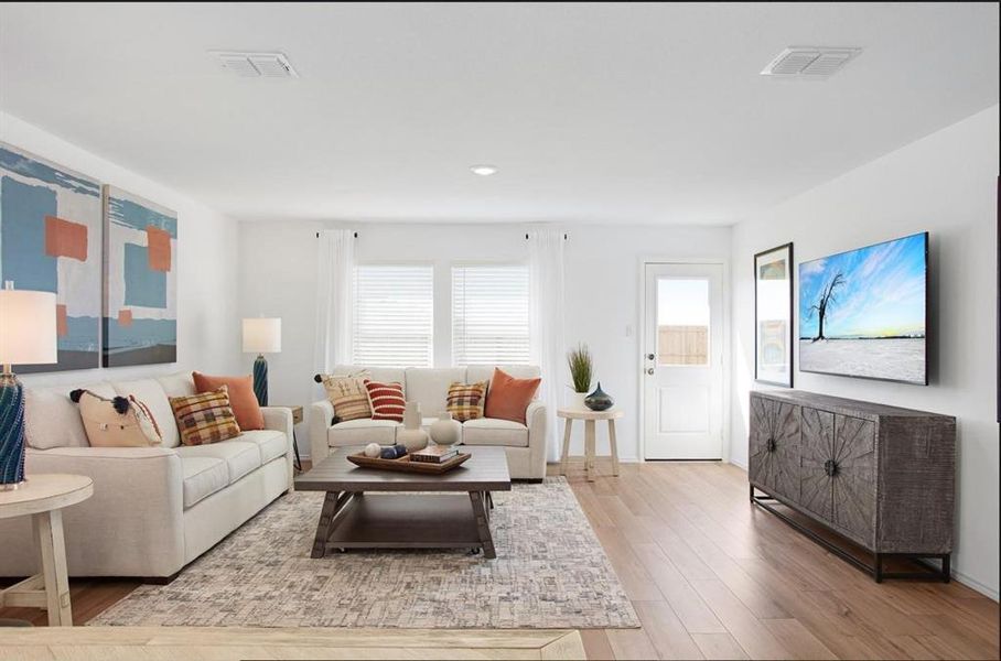 Living room featuring light hardwood / wood-style floors and plenty of natural light