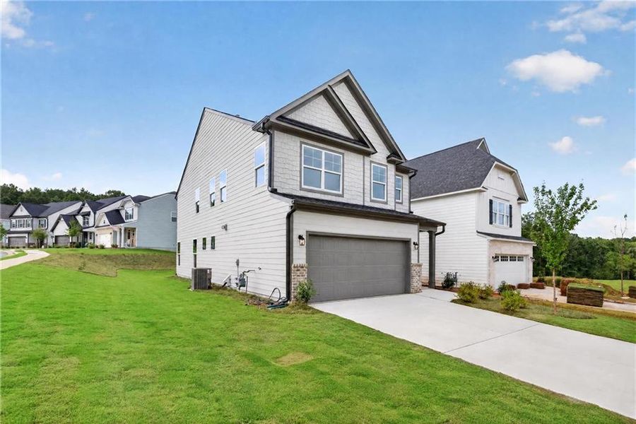 Front exterior of a new home in Villas at Dawsonville, Dawsonville, GA, highlighting curb appeal (Image 25). Front exterior of a new home in Villas at Dawsonville, Dawsonville, GA, highlighting curb appeal (Image 25).