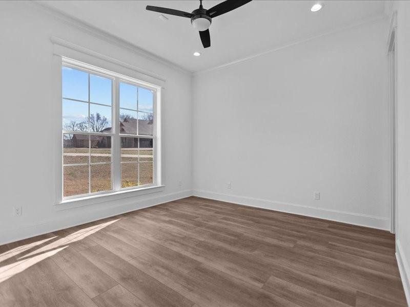 Spare room with dark wood-type flooring, crown molding, ceiling fan, and recessed lighting