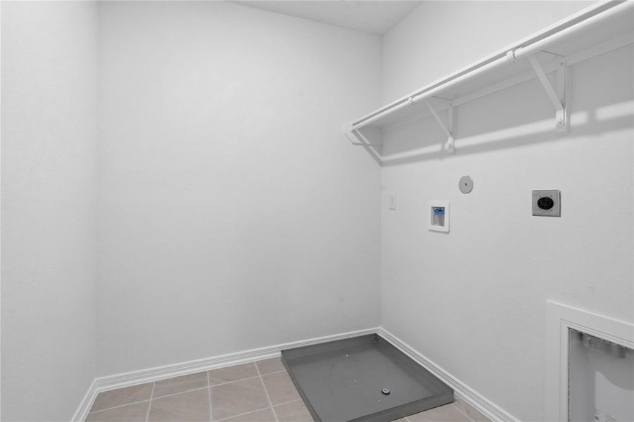 Convenient laundry room featuring added storage shelf and rod. Convenient laundry room featuring added storage shelf and rod.
