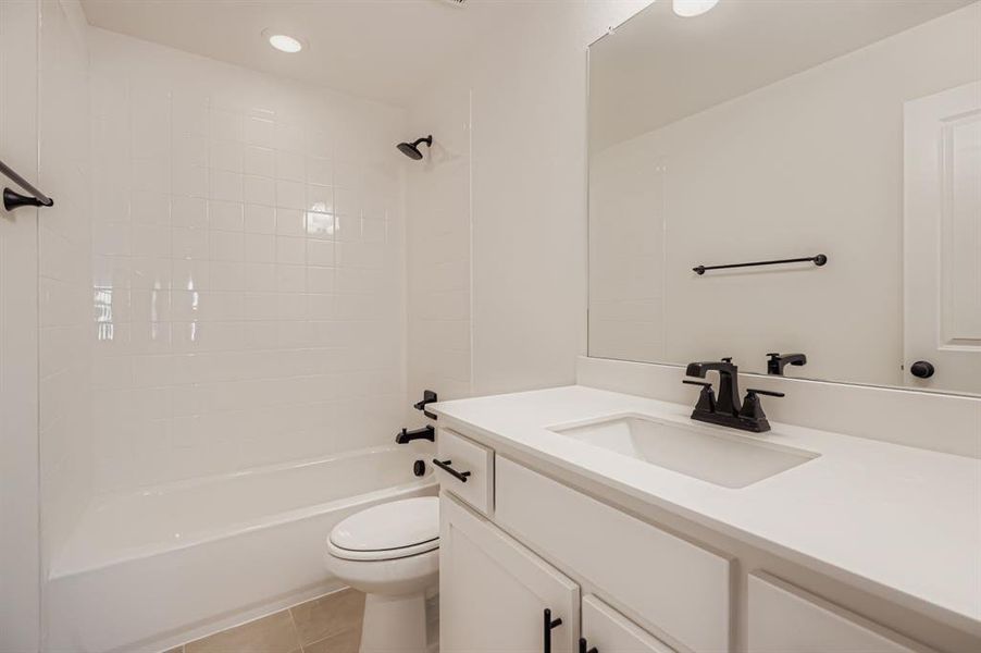 Full bath with vanity, light tile patterned flooring, bathtub / shower combination, and recessed lighting Full bath with vanity, light tile patterned flooring, bathtub / shower combination, and recessed lighting