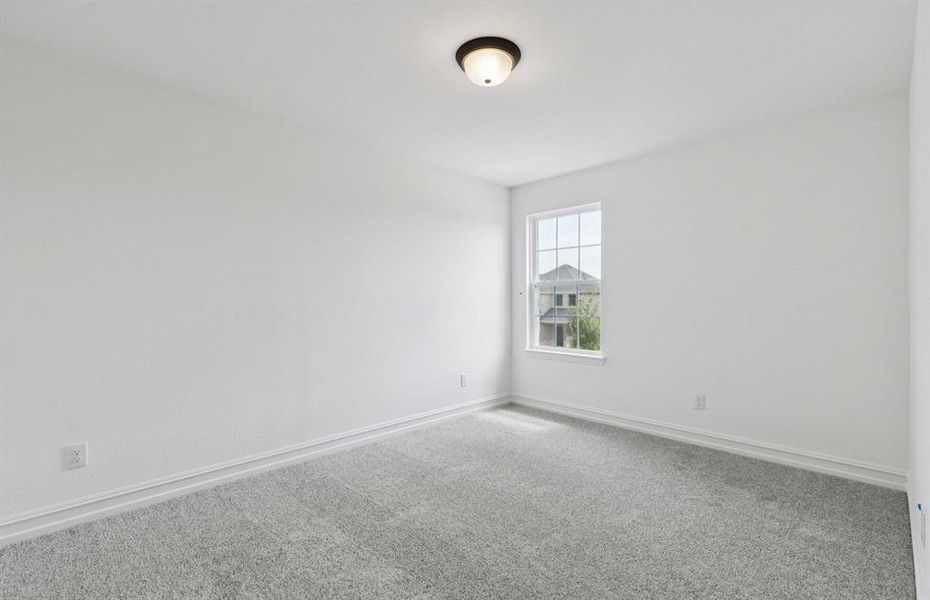 Spacious secondary bedroom features ample closet space   *Real home pictured