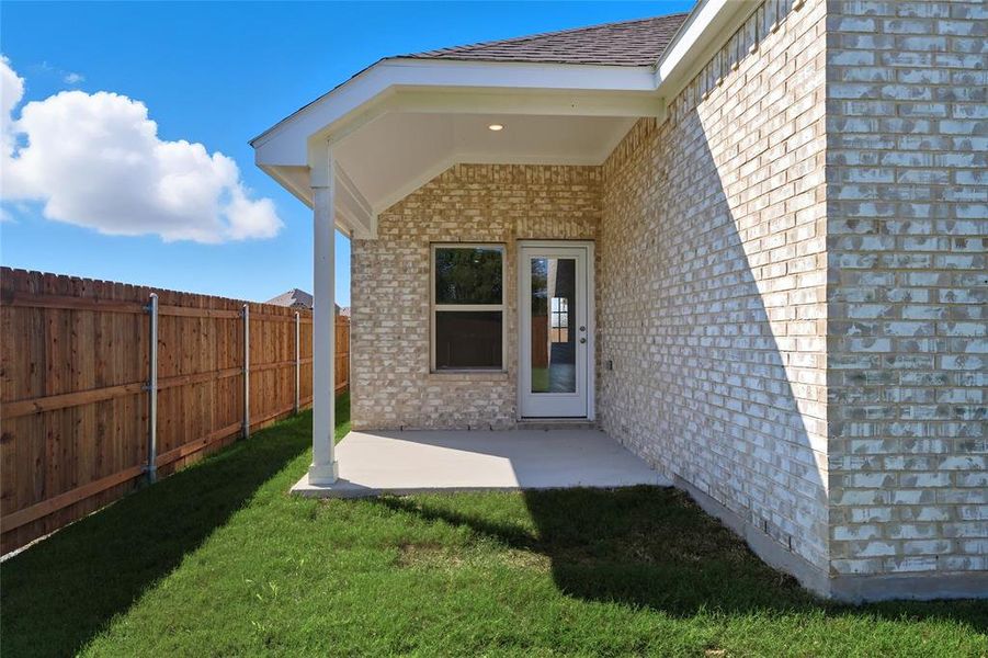 Entrance to property with brick siding and a patio area Entrance to property with brick siding and a patio area