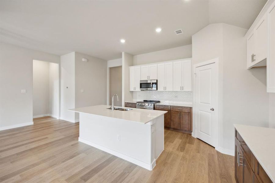 Here you can see the pantry and the bottom cabinets with a warm wood finish