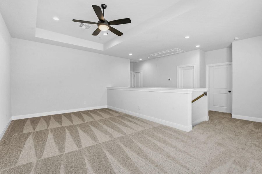 Spare room featuring recessed lighting, light colored carpet, and ceiling fan