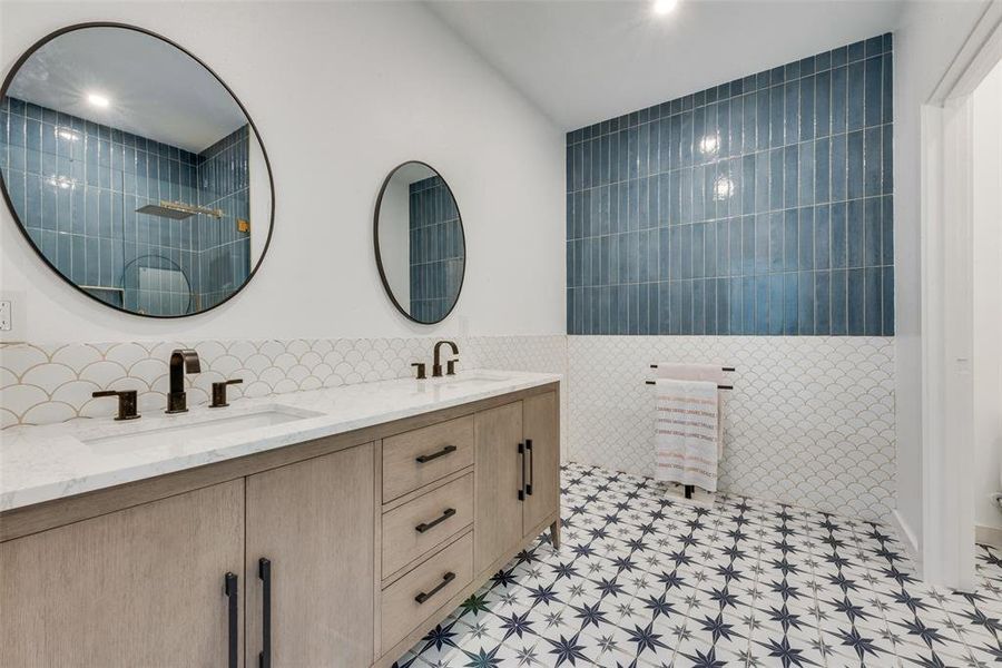 Bathroom featuring tile walls and vanity