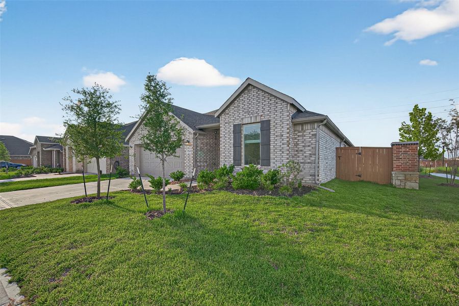 Front exterior of a new home in Sunterra, Katy, TX, highlighting curb appeal (Image 21). Front exterior of a new home in Sunterra, Katy, TX, highlighting curb appeal (Image 21).