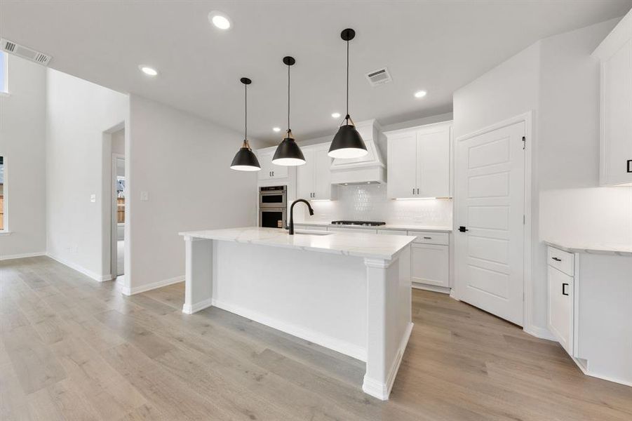 Featuring a spacious kitchen island that overlooks the family and dining rooms, the chef in the family will never be left out of the party in this dream kitchen! Featuring a spacious kitchen island that overlooks the family and dining rooms, the chef in the family will never be left out of the party in this dream kitchen!