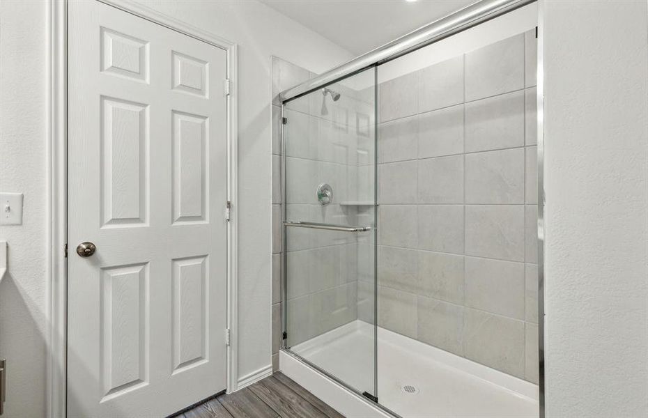 Owner's bath with double vanity and spacious shower*Real home pictured