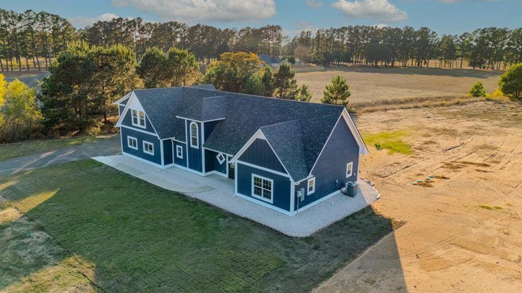 View from above of property featuring a tree filled landscape