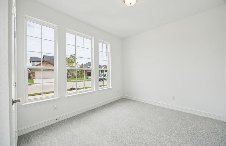 Spacious secondary bedroom features ample closet space  *Real home pictured
