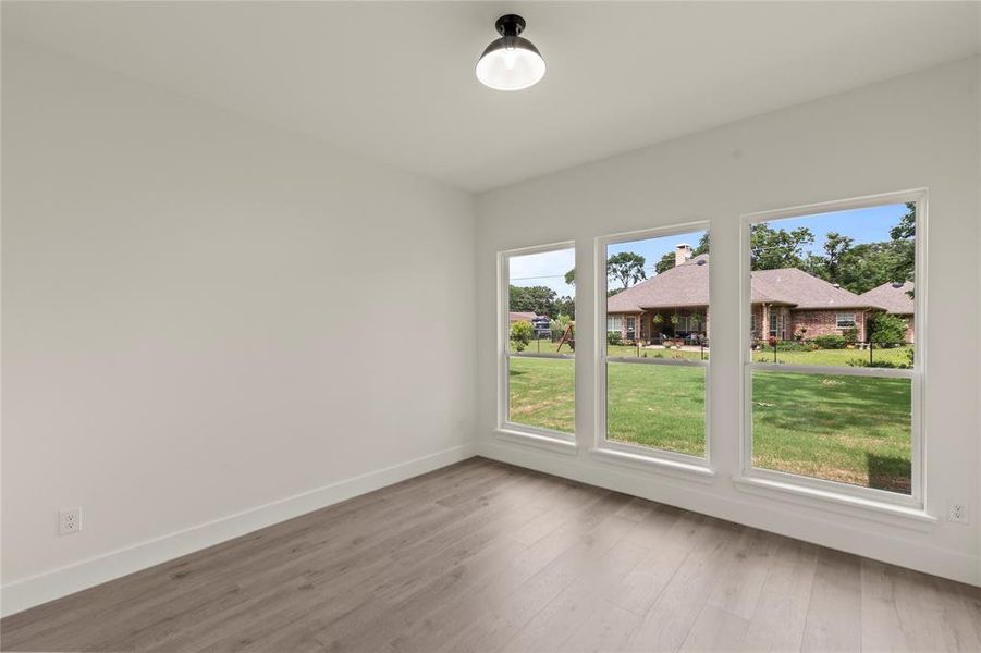 Empty room with wood finished floors and baseboards