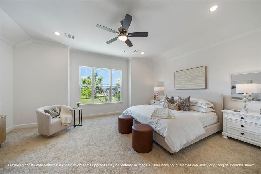 Primary Retreat: A spaciously lit sanctuary, complete with a ceiling fan for personalized comfort and views overlooking the front of the home.