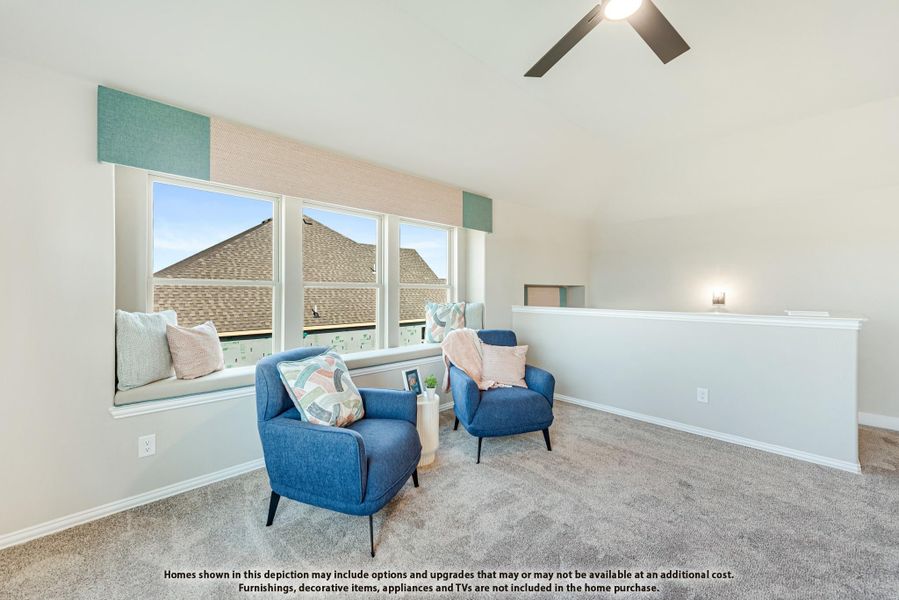 Loft sitting area with vaulted ceiling, window seat, two blue chairs, and ceiling fan Loft sitting area with vaulted ceiling, window seat, two blue chairs, and ceiling fan