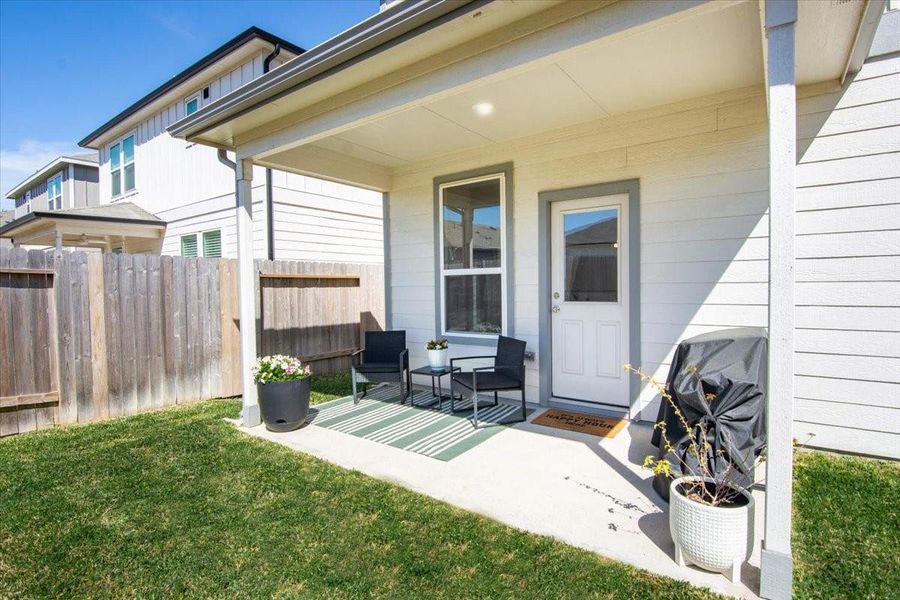The back yard features a cozy covered patio ready for those summertime grill nights!