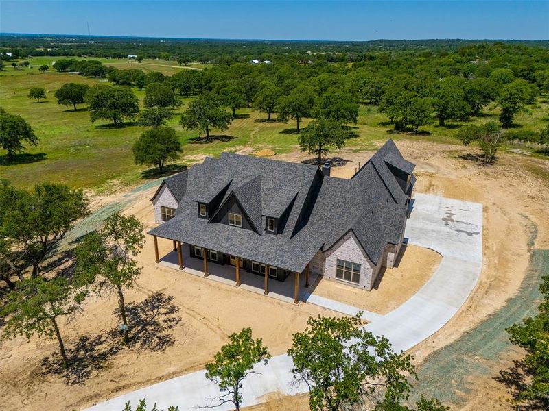 Front exterior of a new home in , Poolville, TX, highlighting curb appeal (Image 1). Front exterior of a new home in , Poolville, TX, highlighting curb appeal (Image 1).