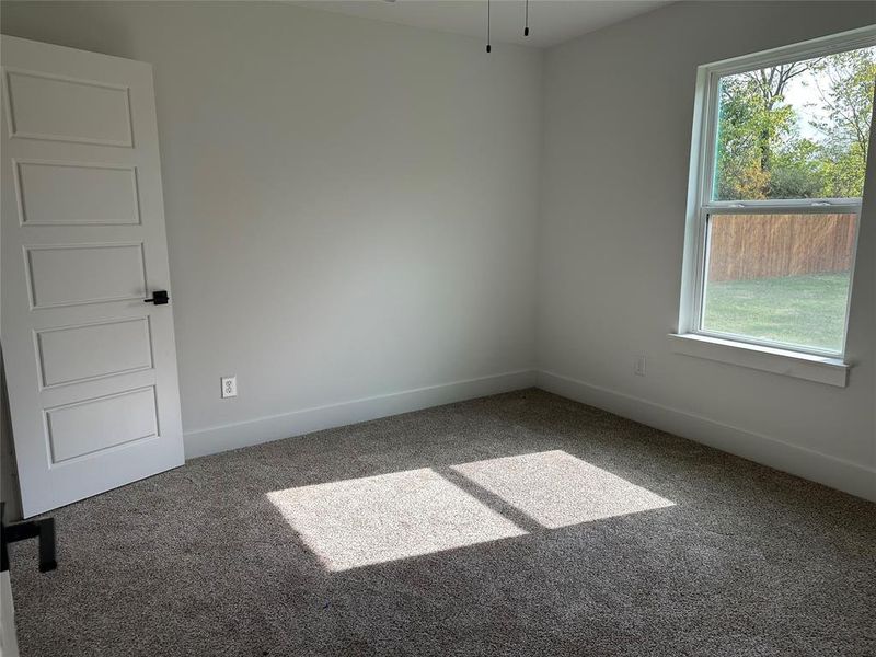 Empty room featuring carpet and baseboards