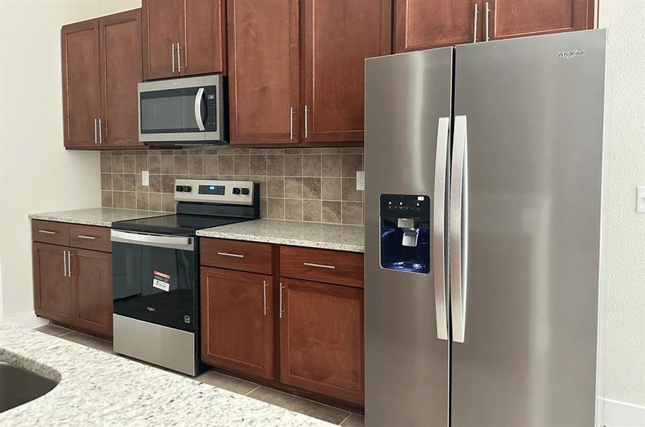 Stainless Whirlpool appliances. Refrigerator included.