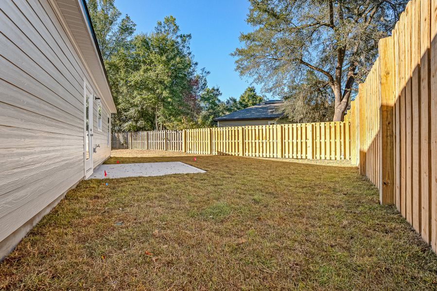 Exterior details and patio area of a home in Live Oak Cottages, Freeport (Image 23).