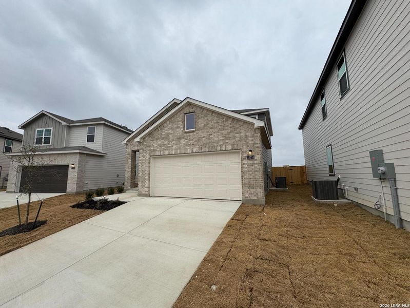 Front exterior of a new home in Hennersby Hollow, San Antonio, TX, highlighting curb appeal (Image 1). Front exterior of a new home in Hennersby Hollow, San Antonio, TX, highlighting curb appeal (Image 1).