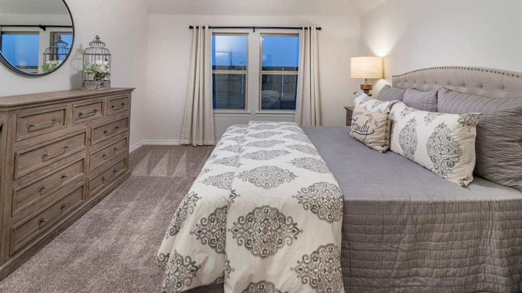 Bedroom featuring dark carpet and baseboards Bedroom featuring dark carpet and baseboards