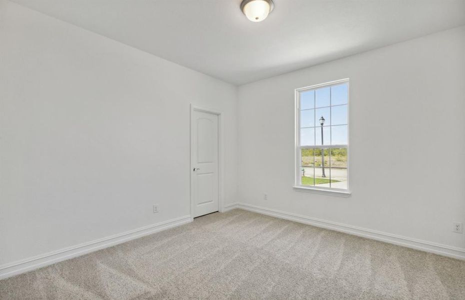 Spacious secondary bedroom with ample closet space*real home pictured