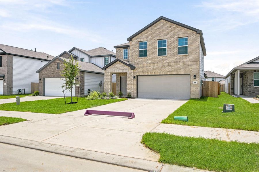 Front exterior of a new home in Maple Woods, Hockley, TX, highlighting curb appeal (Image 16).