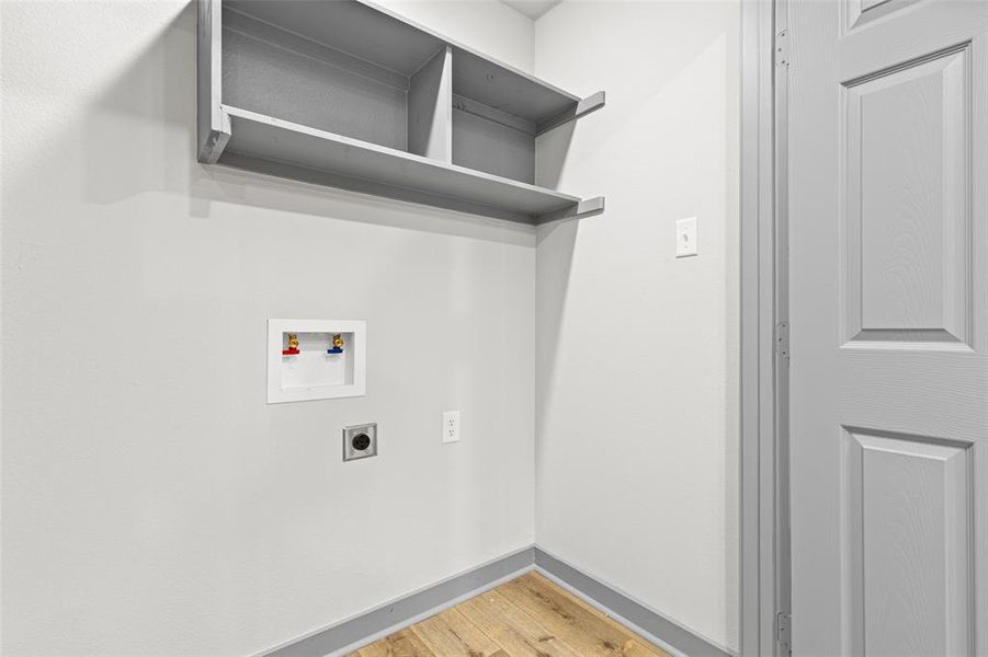 Laundry room with washer hookup, light wood-style floors, and electric dryer hookup Laundry room with washer hookup, light wood-style floors, and electric dryer hookup