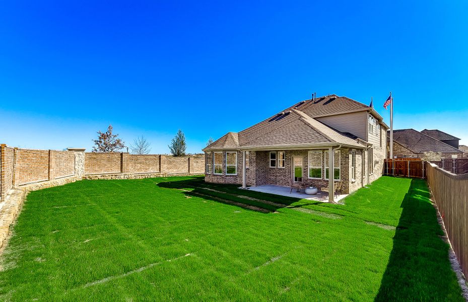 Spacious, fenced-in backyard with covered patio