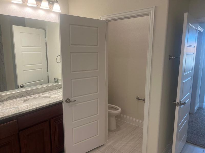 Bathroom featuring vanity and toilet